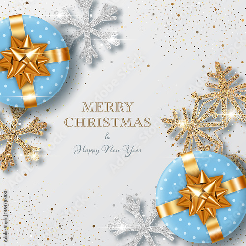 Christmas background with shiny snowflakes made of silver and golden confetti and gift boxes. Design element for greeting card, party invitation or banner