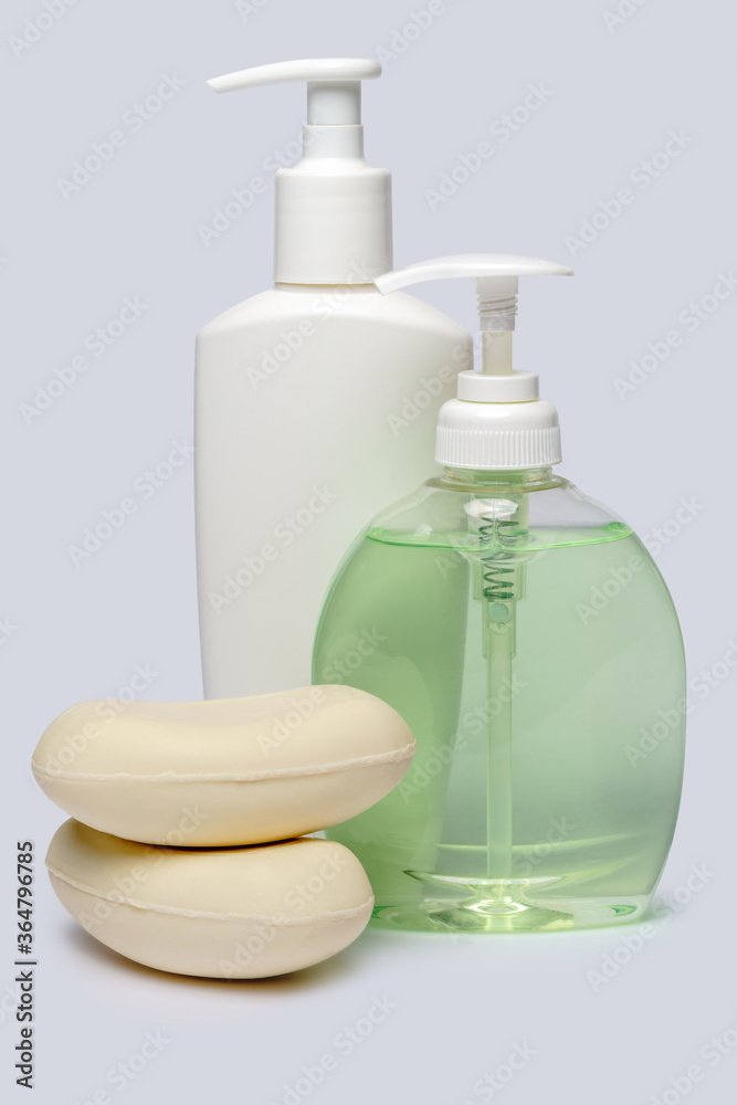 piece of soap and bottle of liquid soap over light grey backgound with clipping path piece of soap and bottle of liquid soap over light grey backgound with clipping path