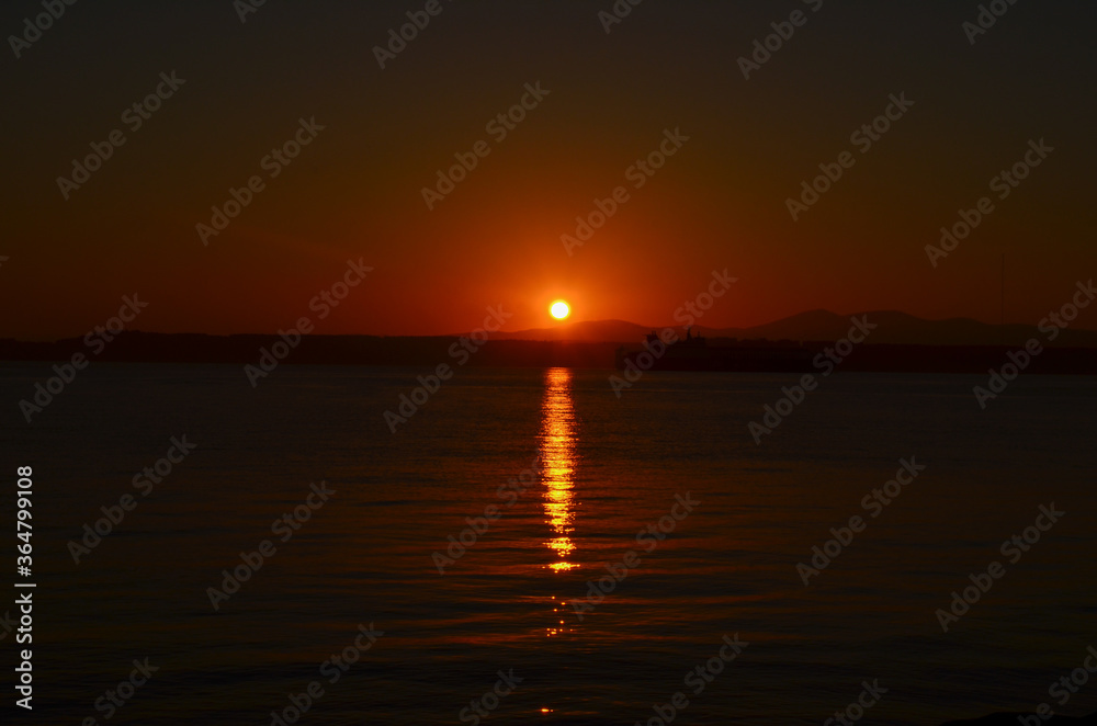 Canakkale with a sunrise and a steamer, morning hours, red colors, sunrise, orange, red, yellow colors
