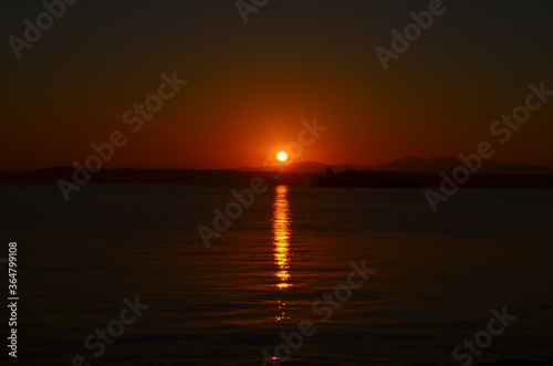 Canakkale with a sunrise and a steamer, morning hours, red colors, sunrise, orange, red, yellow colors
