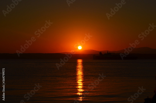 Canakkale with a sunrise and a steamer, morning hours, red colors, sunrise, orange, red, yellow colors  © ismail