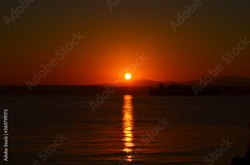 Canakkale with a sunrise and a steamer, morning hours, red colors, sunrise, orange, red, yellow colors
