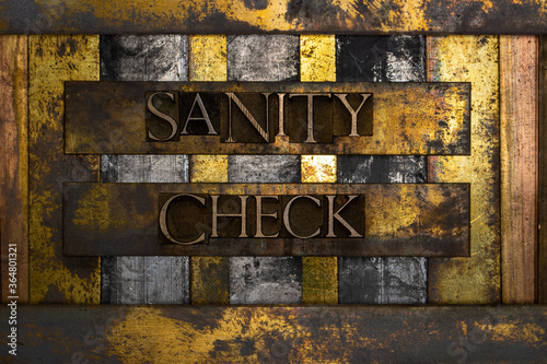 Sanity Check text formed with real authentic typeset letters on vintage textured silver grunge copper and gold background