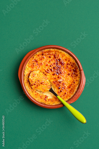 Creme brulee in a clay tray. Homemade burnt cream. French custard dessert