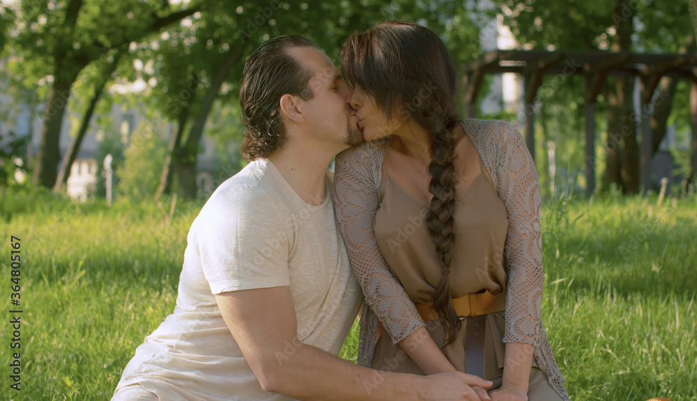 Fototapeta premium Portraits of beautiful couple kissing in the park
