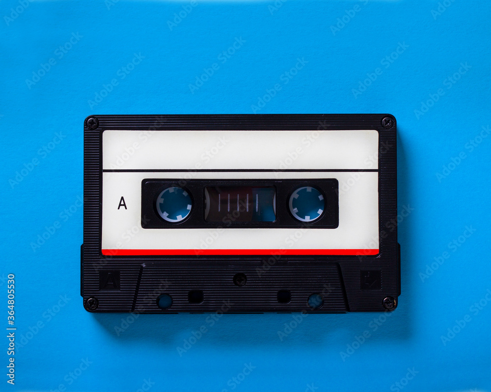 Love music concept retro audio tape cassette isolated on blue background, pop art design, close up