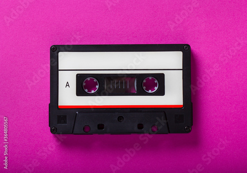 Love music concept retro audio tape cassette isolated on pink background, pop art design, close up