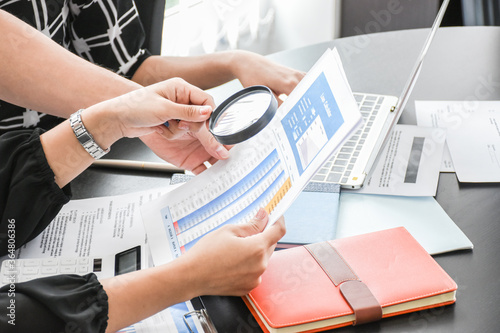 Group of business people working together to analyze and examine the statistical documents on the desk in the Office. Business success.