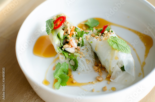 Spring rolls served with shrimp on a white plate. Cooking. National cuisine