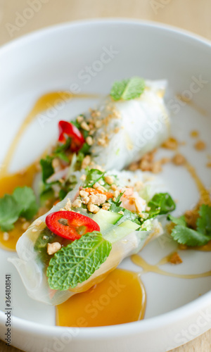 Spring rolls served with shrimp on a white plate. Cooking. National cuisine
