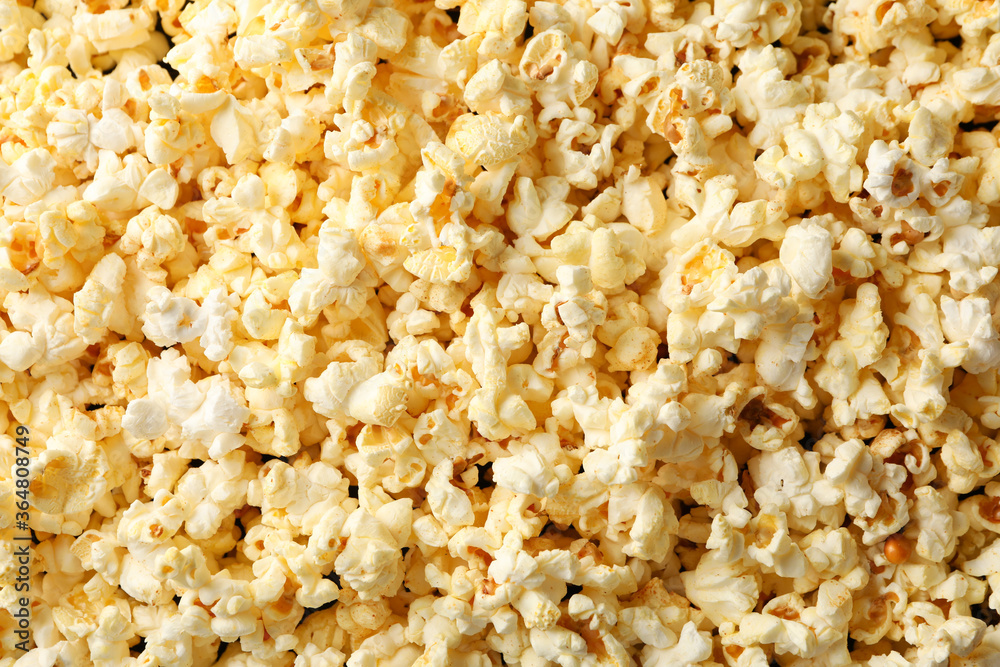 Tasty popcorn on whole background. Food for watching cinema