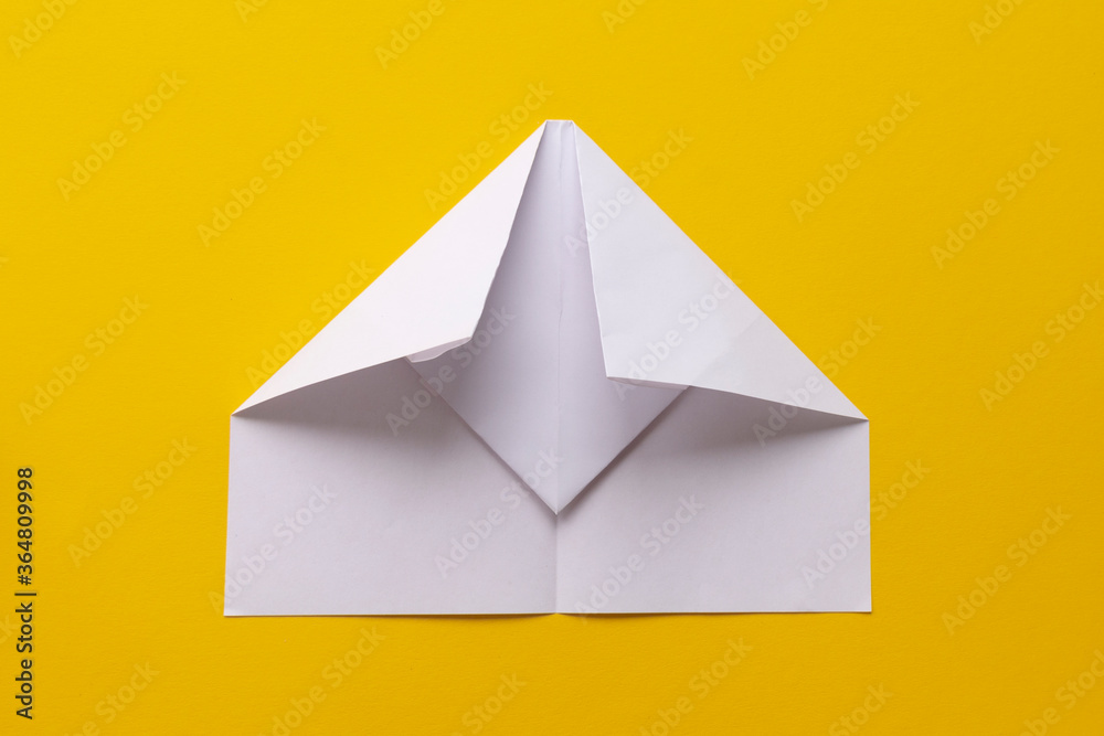 assembly procedure of a paper white airplane. Origami. assembly procedure of a paper white airplane. Origami.