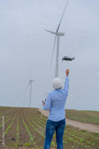 Engineer  flying drone in wind park.