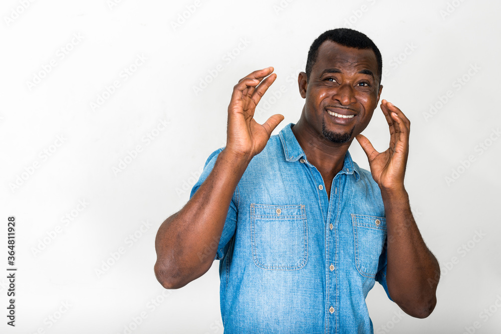 Portrait of handsome bearded African man wearing denim shirt Portrait of handsome bearded African man wearing denim shirt