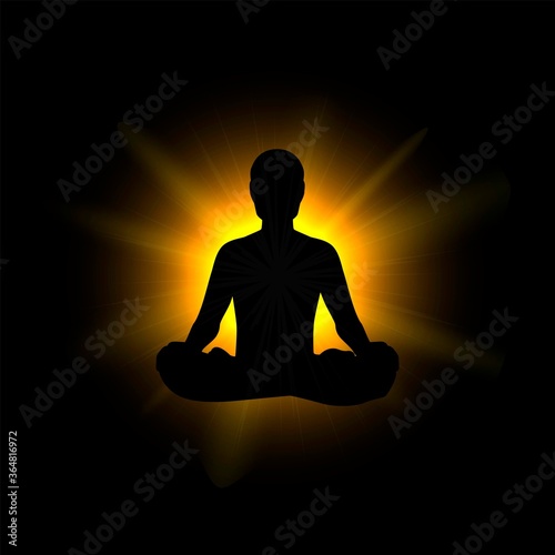 Black silhouette of a man sitting in a lotus position against a background of bright light