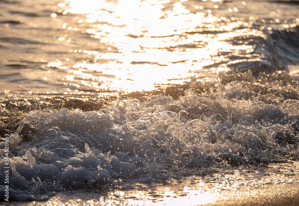 Obraz premium wave splash sea beach close up sunrise