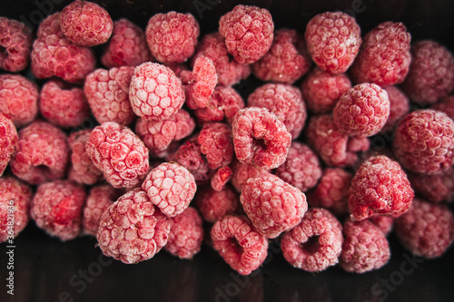 frozen raspberry in a lunch box on white background photo