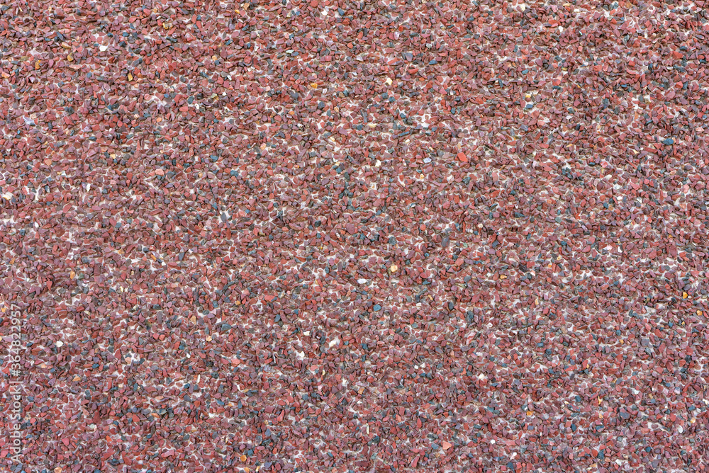 Wall decorated with small brown pebbles, background. Wall decorated with small brown pebbles, background.