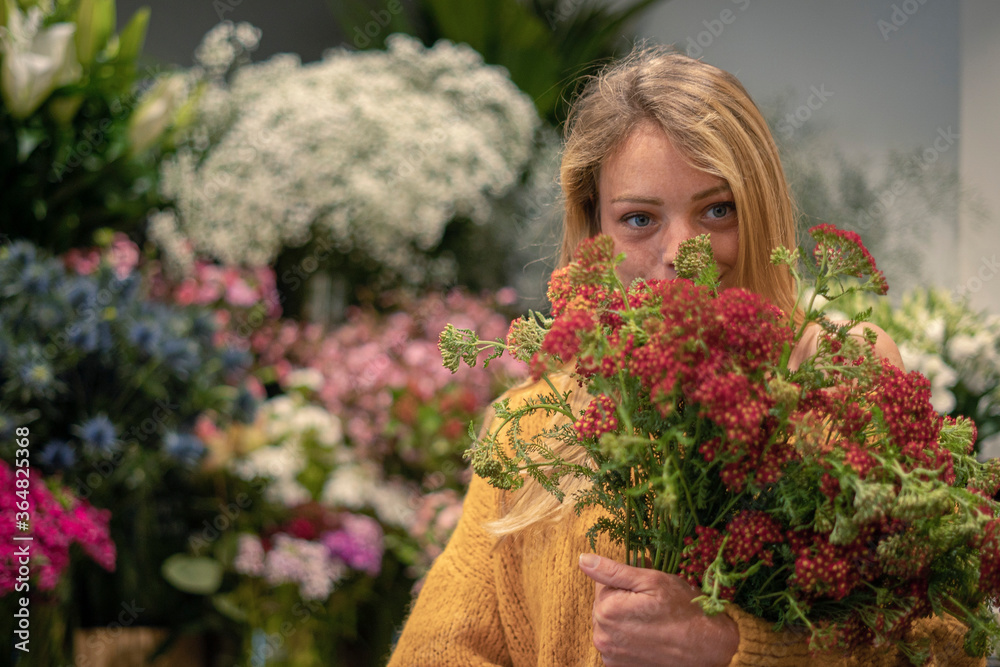 Young woman standing in flower shop Young woman standing in flower shop