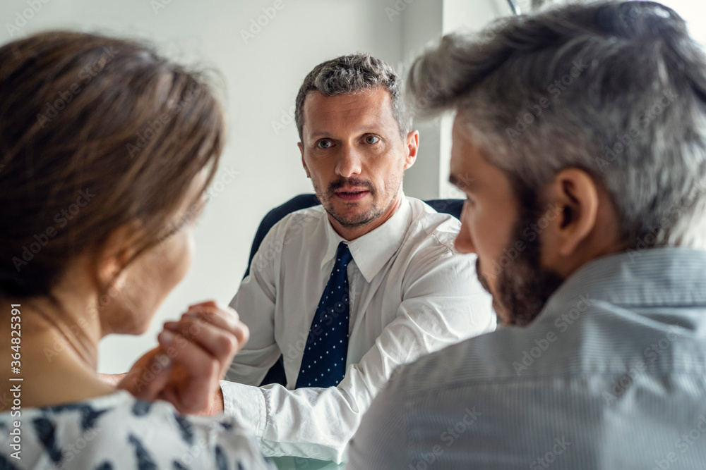 Real estate agent discussing with couple Real estate agent discussing with couple