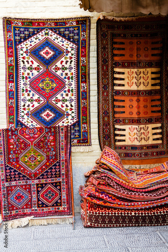 ISFAHAN, IRAN - NOV 20, 2016: Traditional iranian carpets, rugs and scarfs shop in Isfahan bazaar. Esfahan bazaar is one of the oldest and biggest in Iran. photo