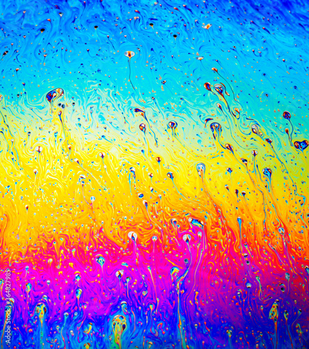 Coloful rainbow psychedelic abstract patternt on soap bubble surface. Macro shot for design