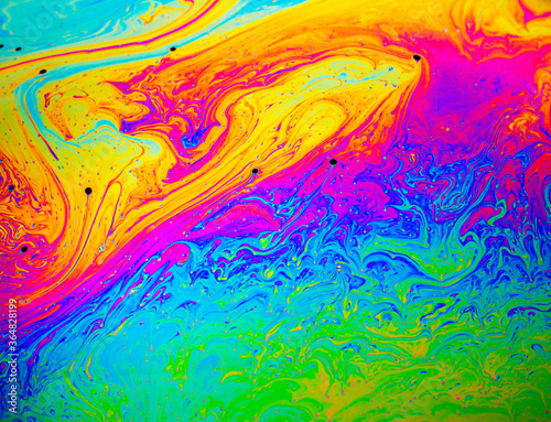 Coloful rainbow psychedelic abstract patternt on soap bubble surface. Macro shot for design