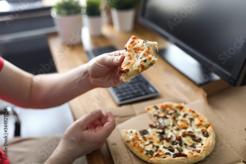Male arms taking big piece of crusty fresh pizza