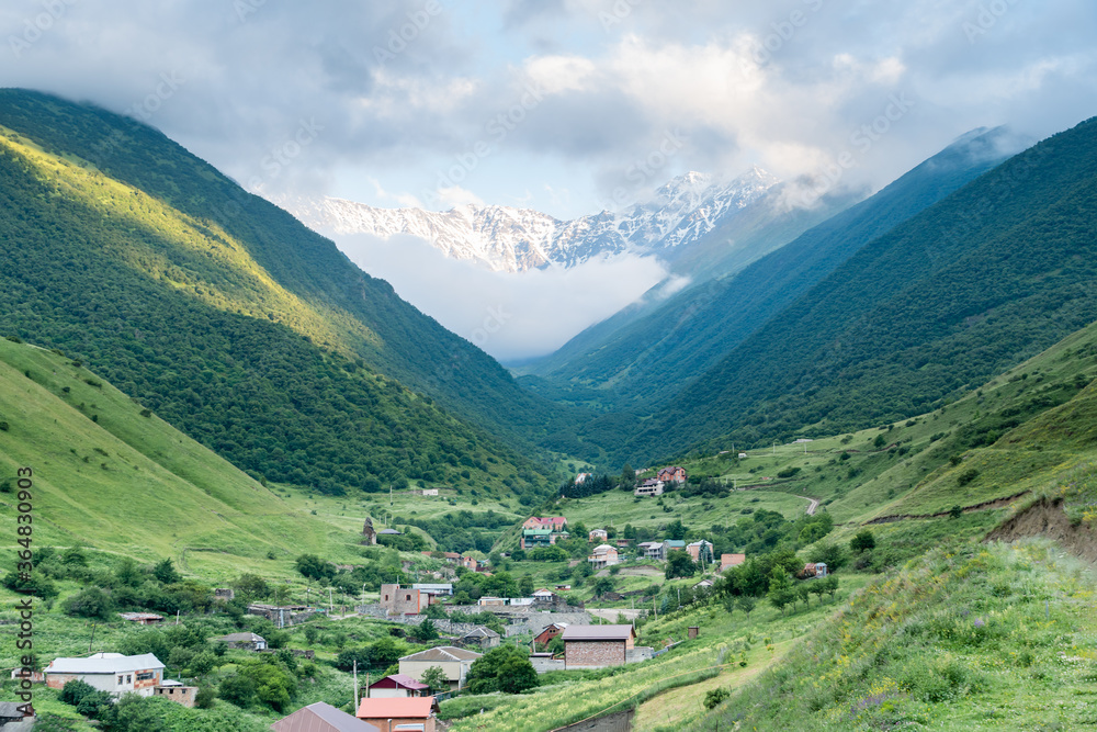 Fantastic view of highest mountain village in north ossetia in mountains with cloudy sky.