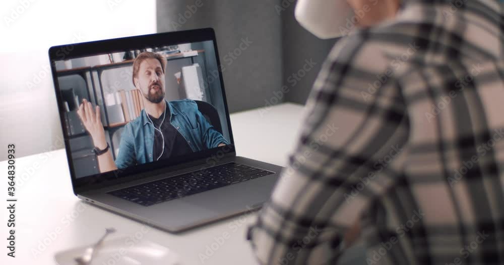 Group of two male and female friends having video chat while staying at home. Happy people spending time during self isolation with laptop and coffee. Group of two male and female friends having video chat while staying at home. Happy people spending time during self isolation with laptop and coffee.