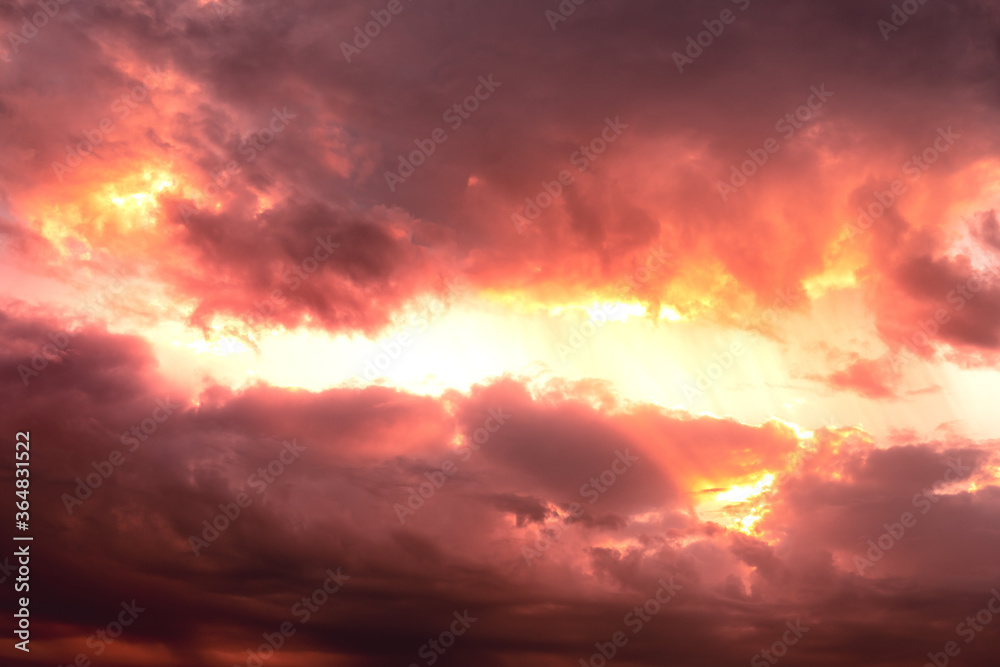 Fototapeta premium dramatic sunset sky with clouds in orange red color