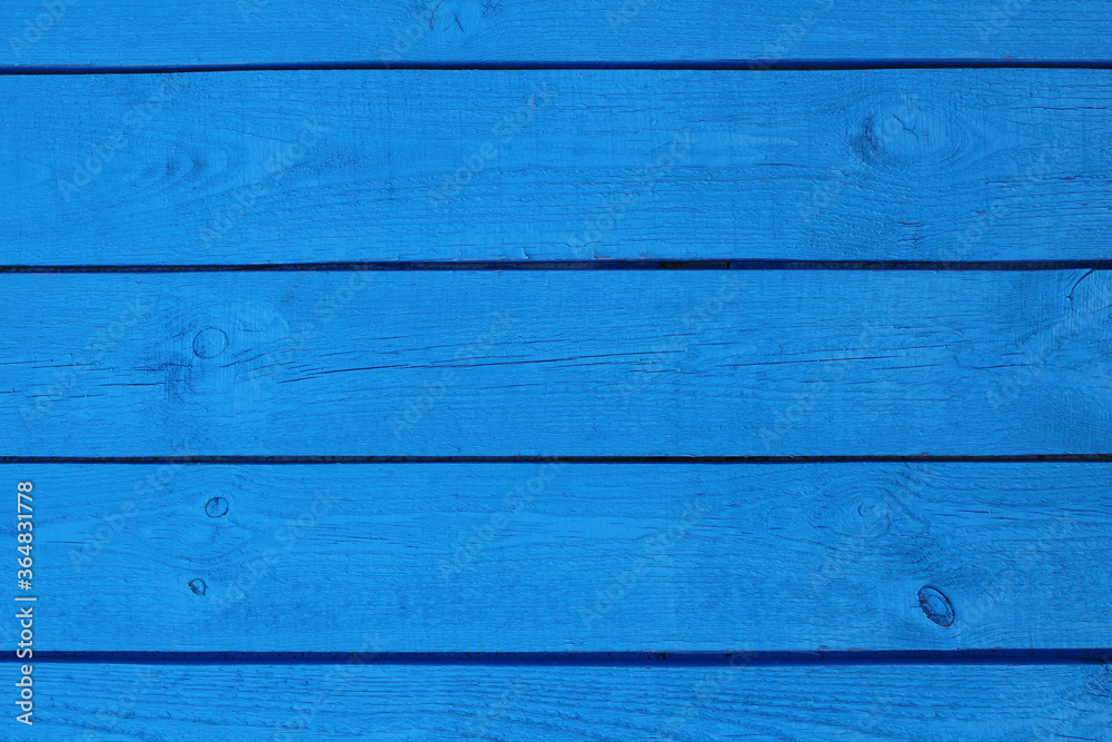 Naklejka premium Wooden boards painted in blue. Close-up. Horizontal view. Background. Texture.