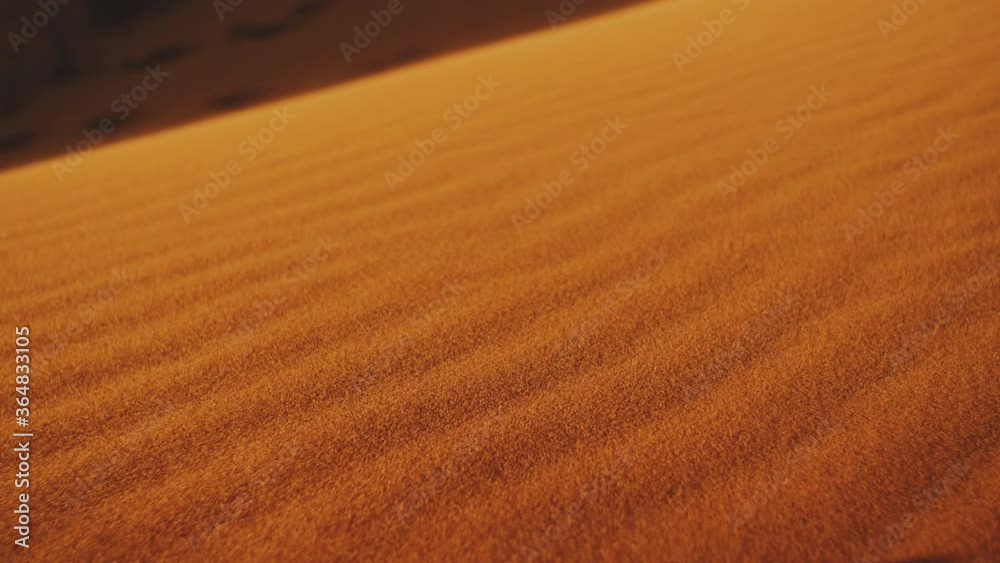 Close-up of wind blows sand in the desert of sand dunes in the Sahara desert at sunset, sun bunnies into camera, 4k
