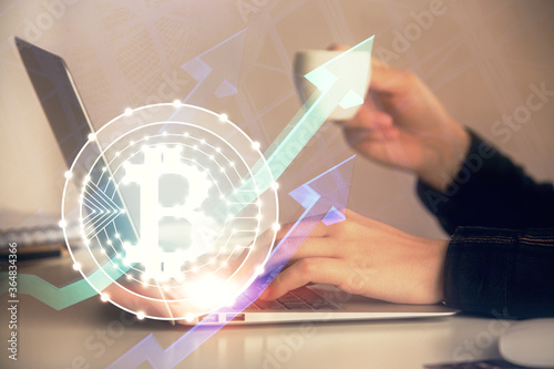 Double exposure of woman hands typing on computer and crypto market theme hologram drawing. Blockchain concept.