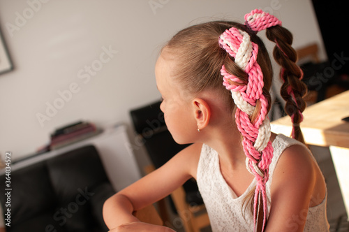 Принти на полотні Colored pigtails on an elastic band for hair on a little girl with blond hair, v