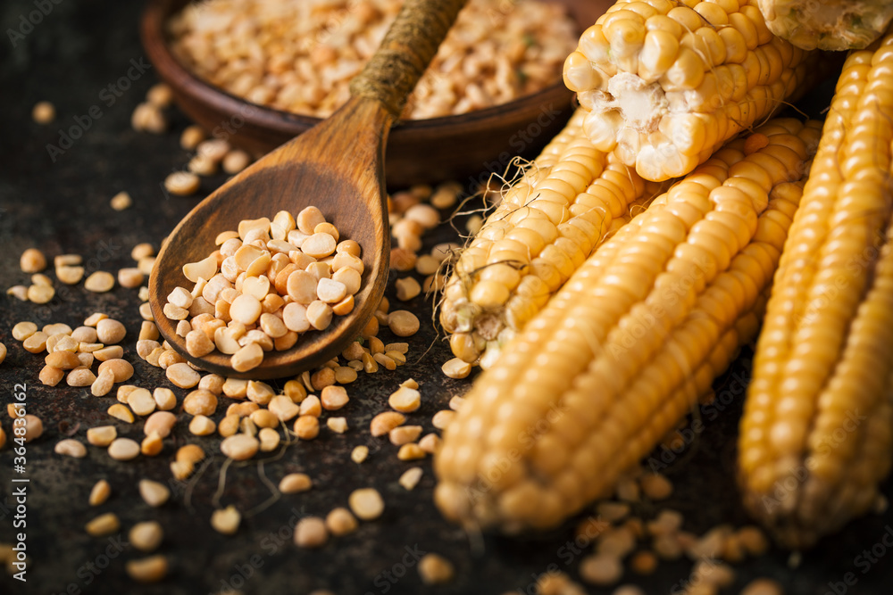 Ripe corn with pea seed on dark background. Ripe corn with pea seed on dark background.