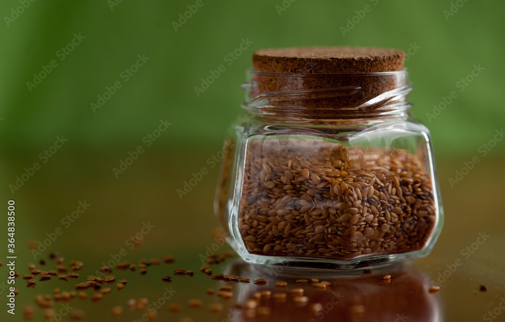 Linseeds in a glass cointainer. Lin seed Linseeds in a glass cointainer. Lin seed