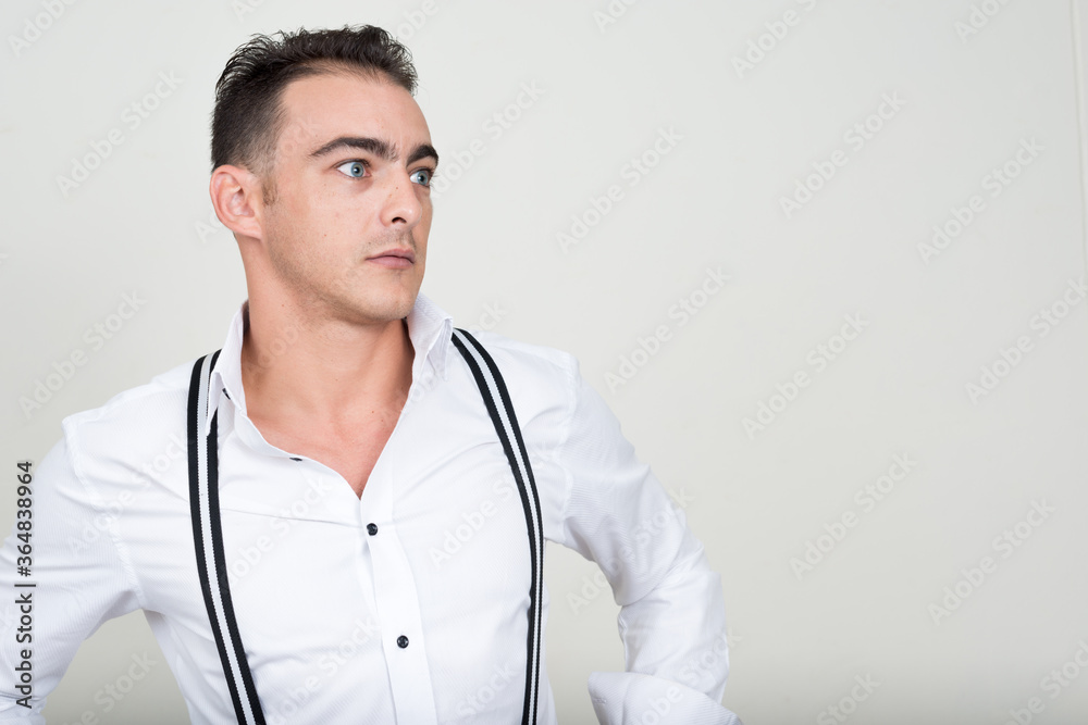 Portrait of young handsome businessman against white background