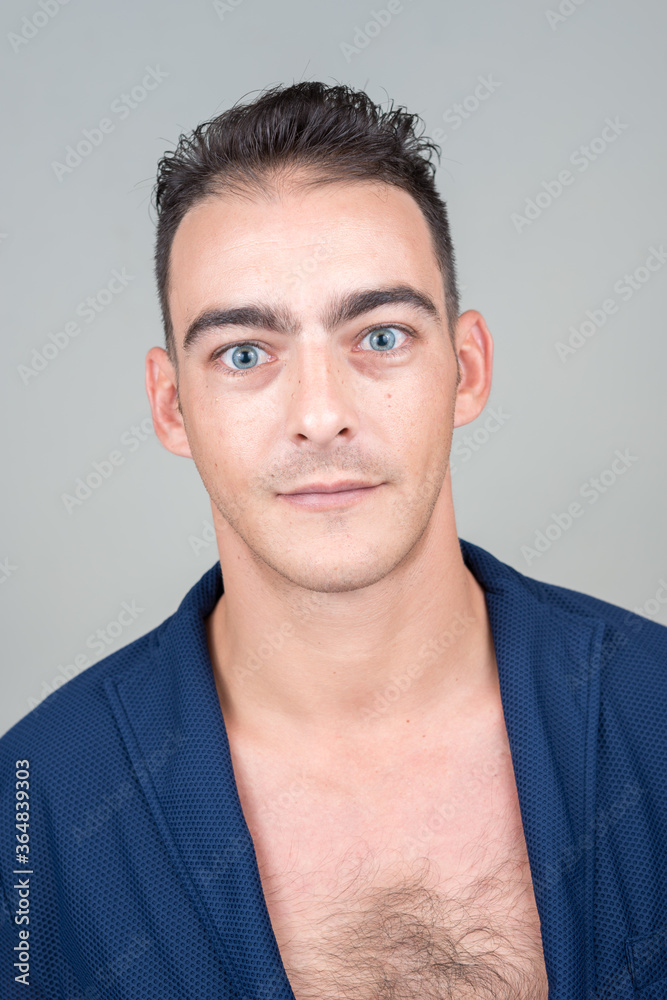 Portrait of young handsome man against white background