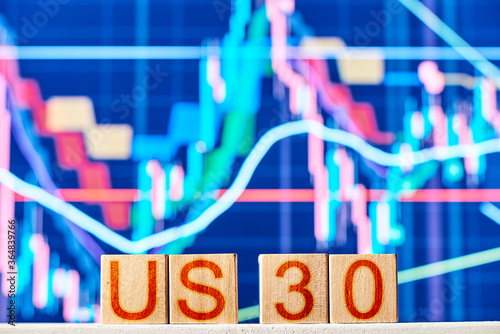 us 30 index concept. wooden blocks with us30 inscription with chart on the background photo