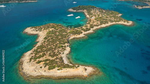 Aerial drone photo of Hinitsa bay a popular anchorage crystal clear turquoise sea bay for yachts and sailboats next to Porto Heli, Saronic gulf, Greece © aerial-drone