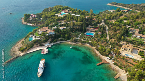 Fototapeta Naklejka Na Ścianę i Meble -  Aerial drone photo of Hinitsa bay a popular anchorage crystal clear turquoise sea bay for yachts and sailboats next to Porto Heli, Saronic gulf, Greece