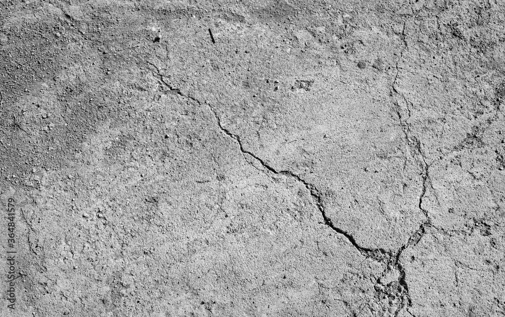 Fototapeta premium Cracked concrete background. Gray wall texture close up.