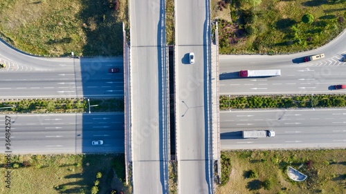 Aerial view of double lane highway, vehicle overpass and side road photo