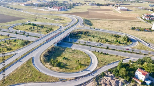 Aerial view of double lane highway, vehicle overpass and side road