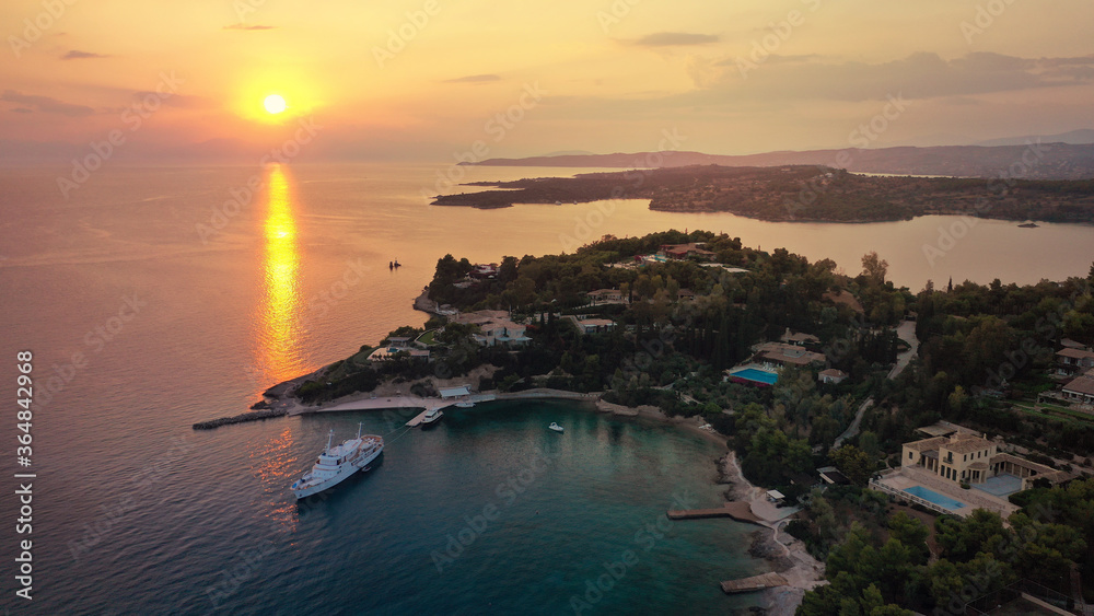 Aerial drone panoramic photo of famous fjord seaside village and bay of Porto Heli in the heart of Argolida prefecture at sunset, Peloponnese, Greece