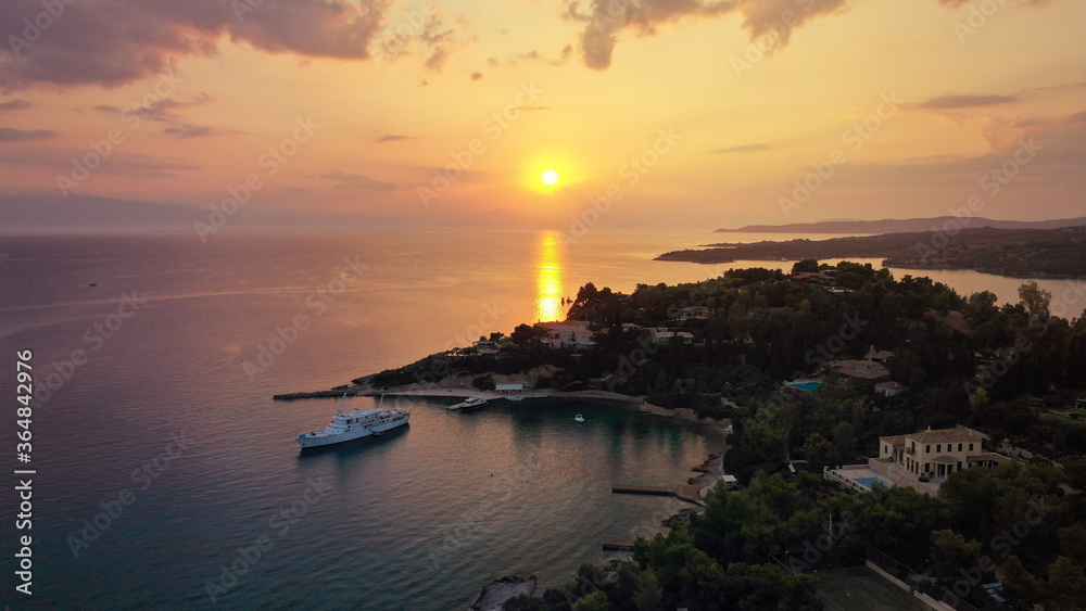 Aerial drone panoramic photo of famous fjord seaside village and bay of Porto Heli in the heart of Argolida prefecture at sunset, Peloponnese, Greece