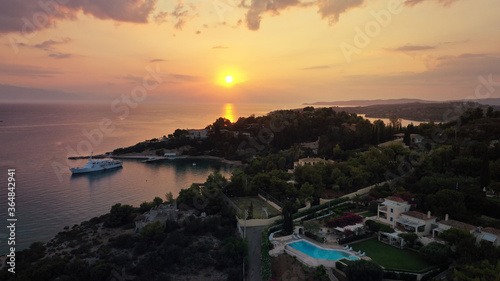 Aerial drone panoramic photo of famous fjord seaside village and bay of Porto Heli in the heart of Argolida prefecture at sunset, Peloponnese, Greece © aerial-drone