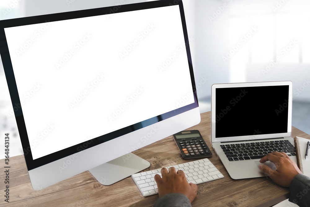 Fototapeta premium Man of business man hand working on laptop computer on wooden desk Laptop with blank screen on table.