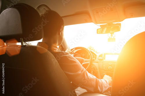 Road trip. Happy young man have fun travel inside car at sunset. Summer vacation concept with driver.